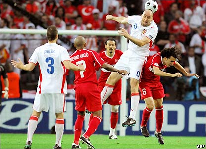 Jan Koller is heading the ball against Mehmet Topal early in action. Koller went on to score his 55th and final goal for the Czech Republic.