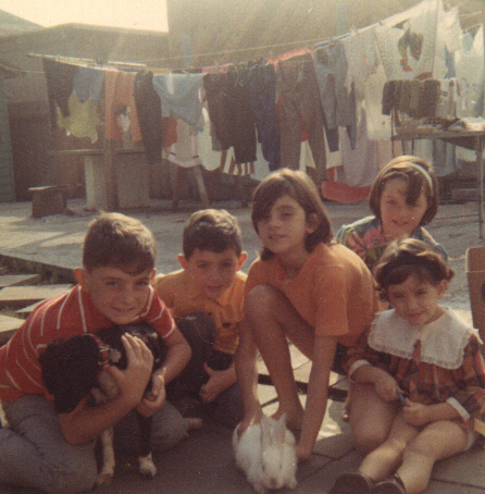 My siblings and me (I'm on the right) ca. 1968.  If you look in the background, you can see one of our early clotheslines lining the backyard.