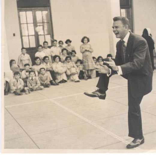 Donald F. Duncan showing children the magic of a yo-yo