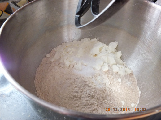 Adding the dry milk and yeast.