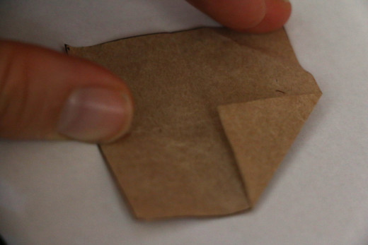 Fold in corners to meet quarters marked by the folds
