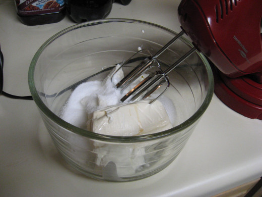 Mix together the cream cheese, sour cream, Splenda, and vanilla. When smooth, blend in Cool Whip.