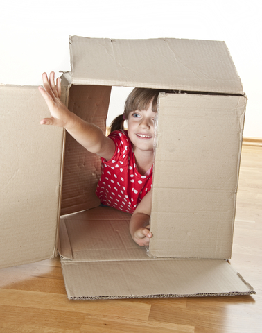 Little girl playing inside box