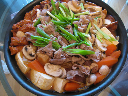 Sukiyaki  is a Japanese dish, of the soup or stew type, prepared and served in the nabemono (Japanese hot pot) style.