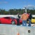 My dad and brother talking with their drive instructor in front of their Ferrari 548 Italia