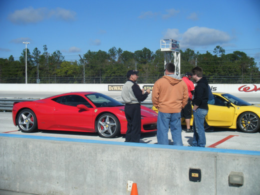 My dad and brother talking with their drive instructor in front of their Ferrari 548 Italia