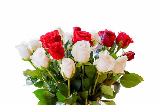 A bouquet of white and red roses symbolizing innocence, purity, and love.