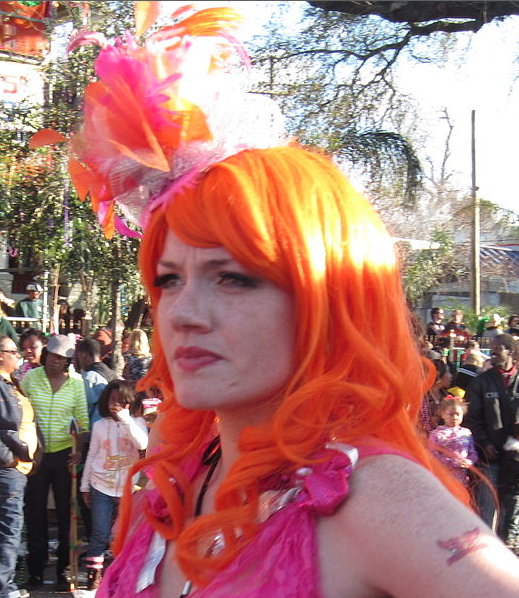 Girl wearing orange wig at New Orleans Mardi Gras. (This is a cropped/edited version of the photo. To see the original, click on the link.)