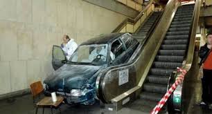 This is a "Master Time Waster." He is letting the escalator take himand his car up to a higher floor
