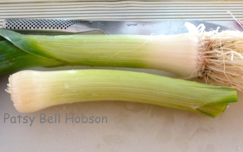 Blanche leeks by covering the base with soil, the reason leeks are so gritty or sandy. This is an optional practice.