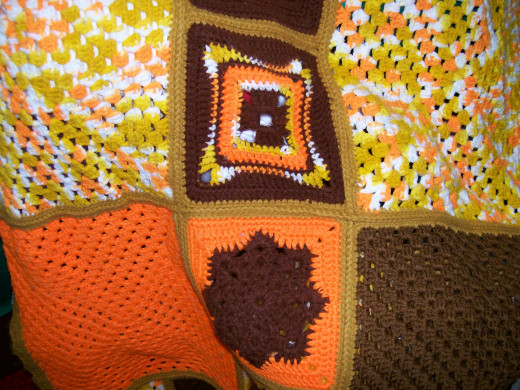 Another snowflake and unique square pattern. Note big granny squares are the original sweater colors.