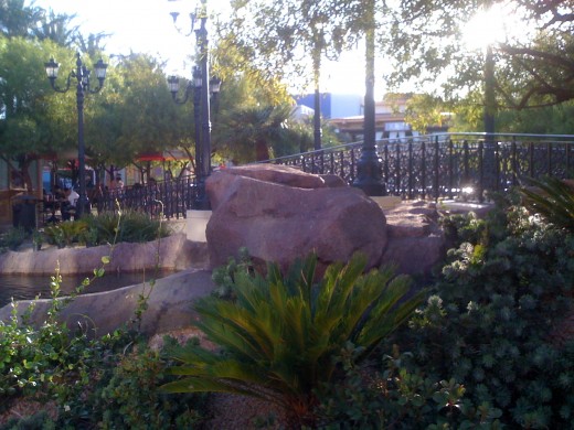 The aroma of various foods permeates through the streets of Town Square, while people relax to enjoy the scenery and calm of the waterways.