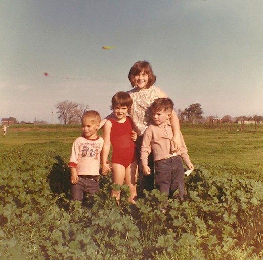 The photo was taken in the pasture during one of our kite flying days. In the background, you can even make out one of the neighbor boys still running with his kite. 