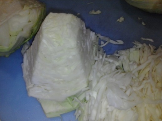 Figure 1-4. Turn the cabbage quarters as you cut. It is easier to make the thinner cuts, and the pieces are easier to eat. Eating sauerkraut should not be like eating spaghetti.