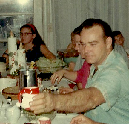 Dad at Christmas 1967, with me in the background.
