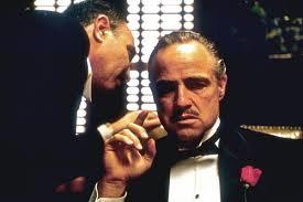 A scene from the movie, The Godfather.  Featured: Godfather of the Corleone Crime Family, Don Vito Corleone (seated), in conference with an Italian undertaker called Bonacera, a desperate man who needs a "favor" from his "friend."