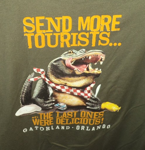 Photo of a t-shirt from Gatorland. "Send more tourists" says the hungry alligator. 
