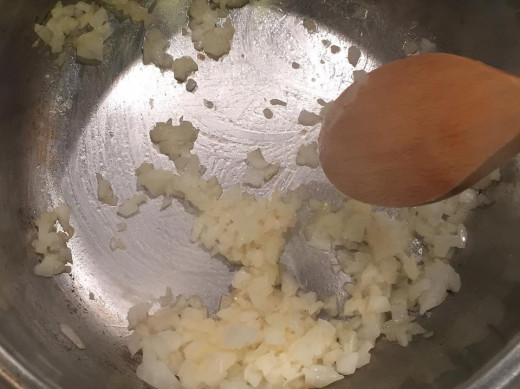 In a saucepan, cook the onions until half transparent. 