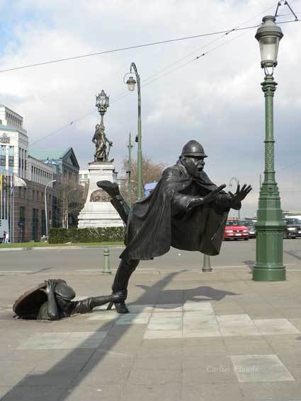 De Vaartkapoen(Brussels , Belgium) :   Low down, a young rebel, the Vaartkapoen, reminiscent of a jack-in-the- box, topples over a policeman higher up, thus overthrowing his authority.   