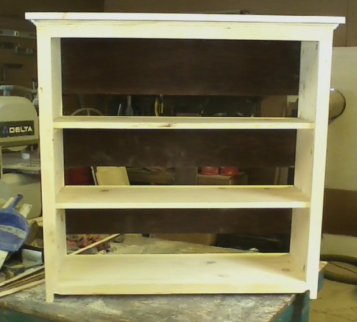 A shelf unit made from pieces of old furniture.