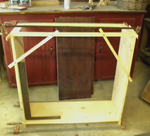 Gluing up the sides, web frame, and bottom shelf to form the case.