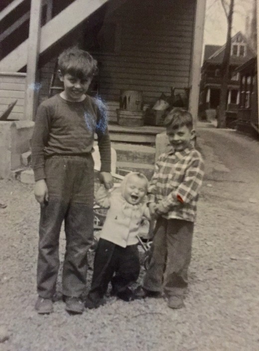 The boy in the middle is me. Although we didn't have much money, we knew how to have fun. You don't know you are poor if everyone else in the neighborhood is poor too.