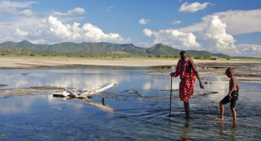 Freedom - is a Masai paddling in the hot springs at Lake Magadi, Kenya, with a young lad (not Masai) in tow. He's showing him the safest places to stand