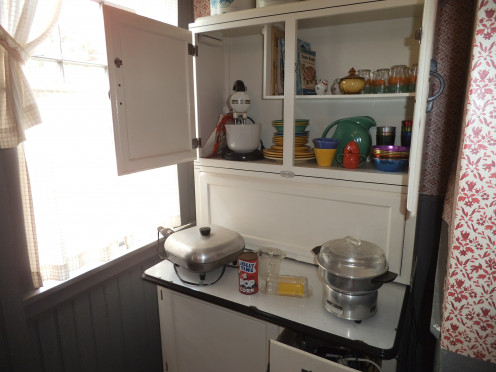 Note the pitcher on the right lower shelf on this old kitchen storage unit (called a Hoosier cabinet).