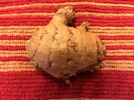 To peel ginger prior to grating, simply use a spoon in an upward motion and the skin will come off.