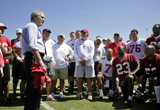 President George W. Bush visiting the Tampa Bay Buccaneers at practice before their game against the Panthers.  The Bucs are currently members of the South Division of the National Football Conference (NFC) in the National Football League (NFL).