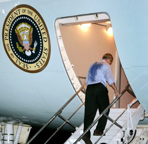 After a hard day's work, (see the president's shirt) President Obama boards Air Force One to head back to Washington, D.C.