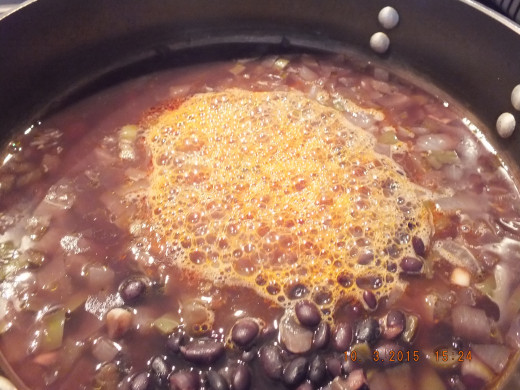 Pour the beer and tomato paste mixture into the dutch oven.
