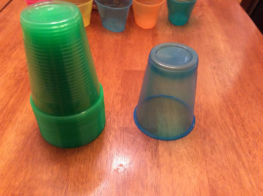 Stack of green and one blue cup