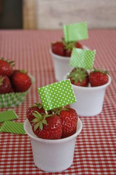 Strawberries in a cup used as place cards