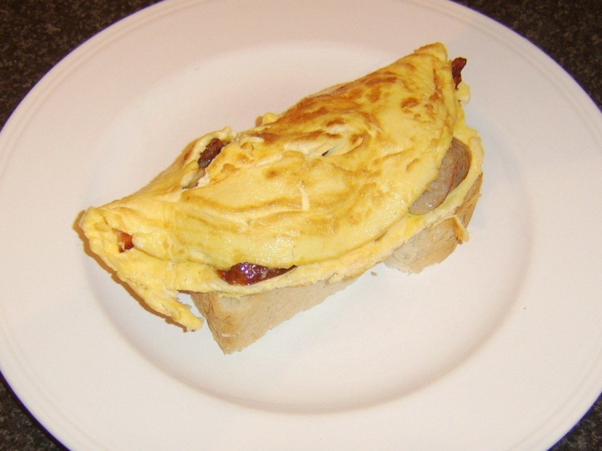 Omelette is carefully laid on first slice of bread