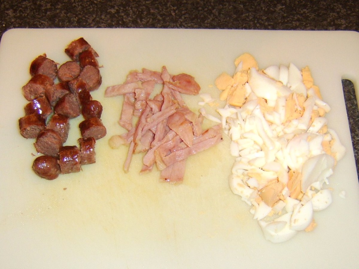 Cooked sausage, bacon and egg are roughly chopped