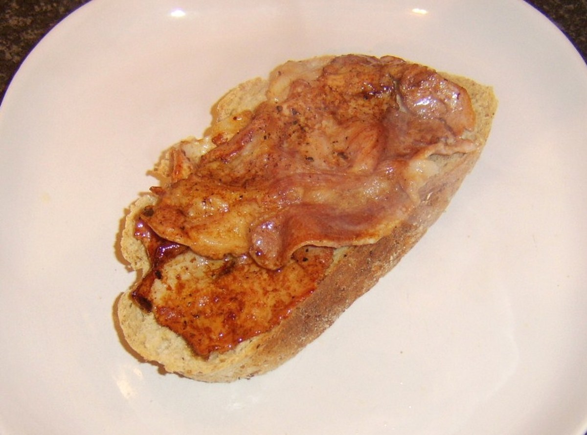 Bacon is laid on slice of bread
