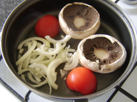 Frying the msuhrooms, tomato and onion