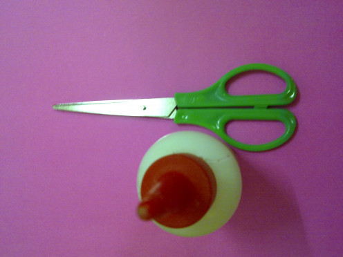 a pair of scissors and a bottle of white glue