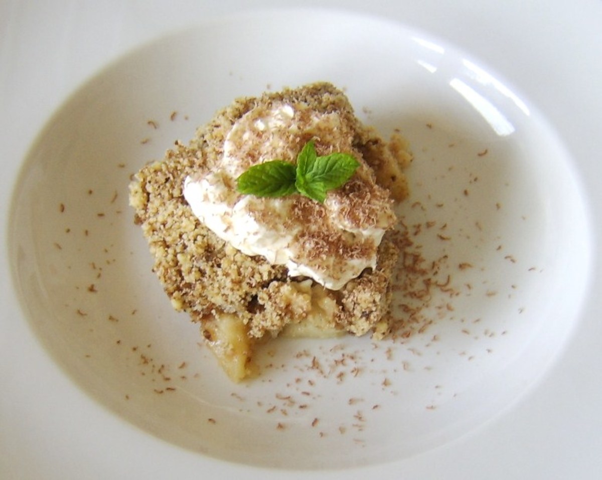 Sticky toffee apple and pineapple crumble with whipped cream and a chocolate dusting