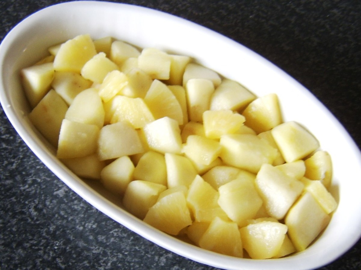 Combined apple and pineapple is laid in the base of an ovenproof dish