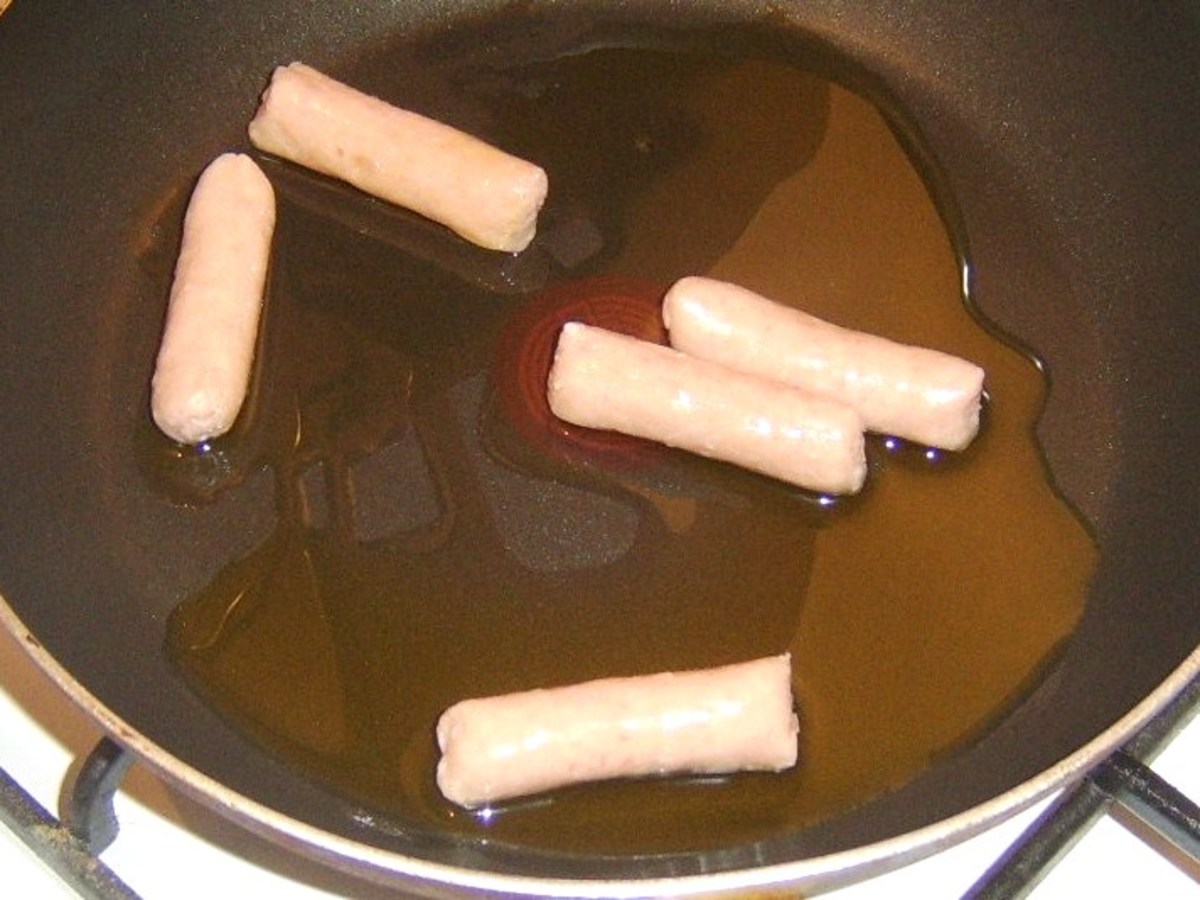 Gently frying mini sausages