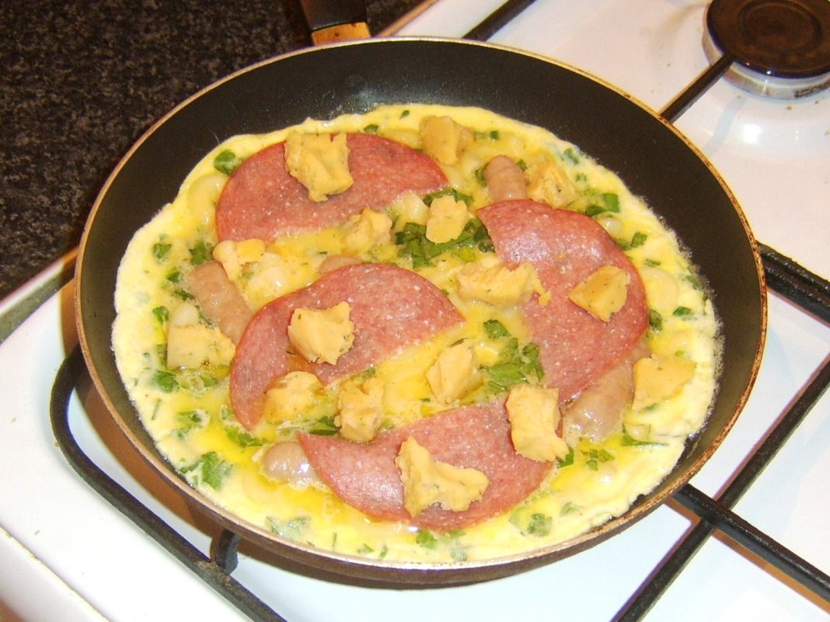 Salami and cheese are added to almost set frittata
