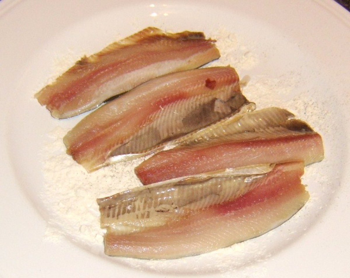 Patting herring fillets in flour