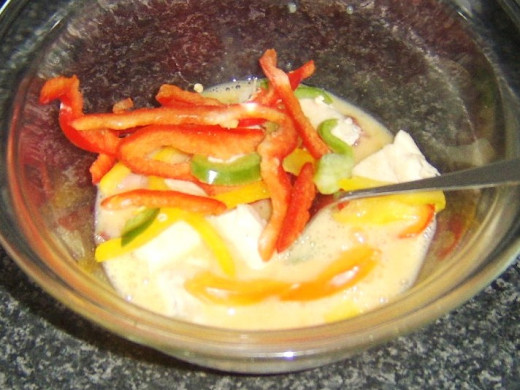 Bacon, chicken and bell peppers are stirred through beaten egg