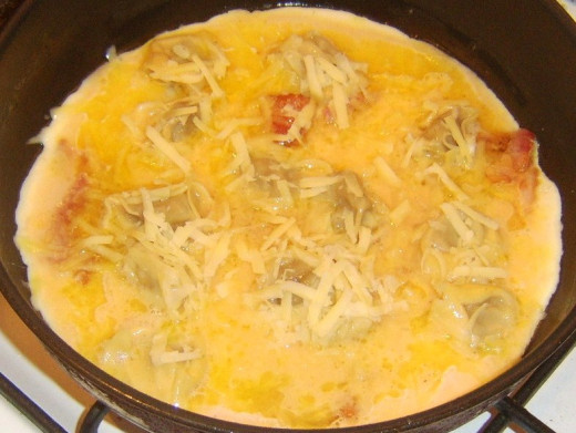 Cheddar cheese is scattered on frittata