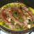 Bacon slices are laid on top of partly set frittata