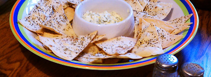 Cheese and fresh chive dip, served here with cilantro rosemary tortilla crisps.