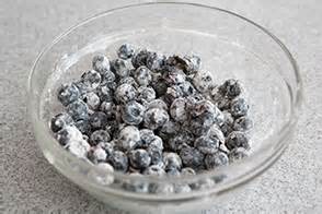 Mix blueberries in flour