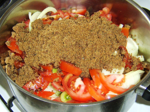 Tomato pickle ingredients are all added to a stock pot